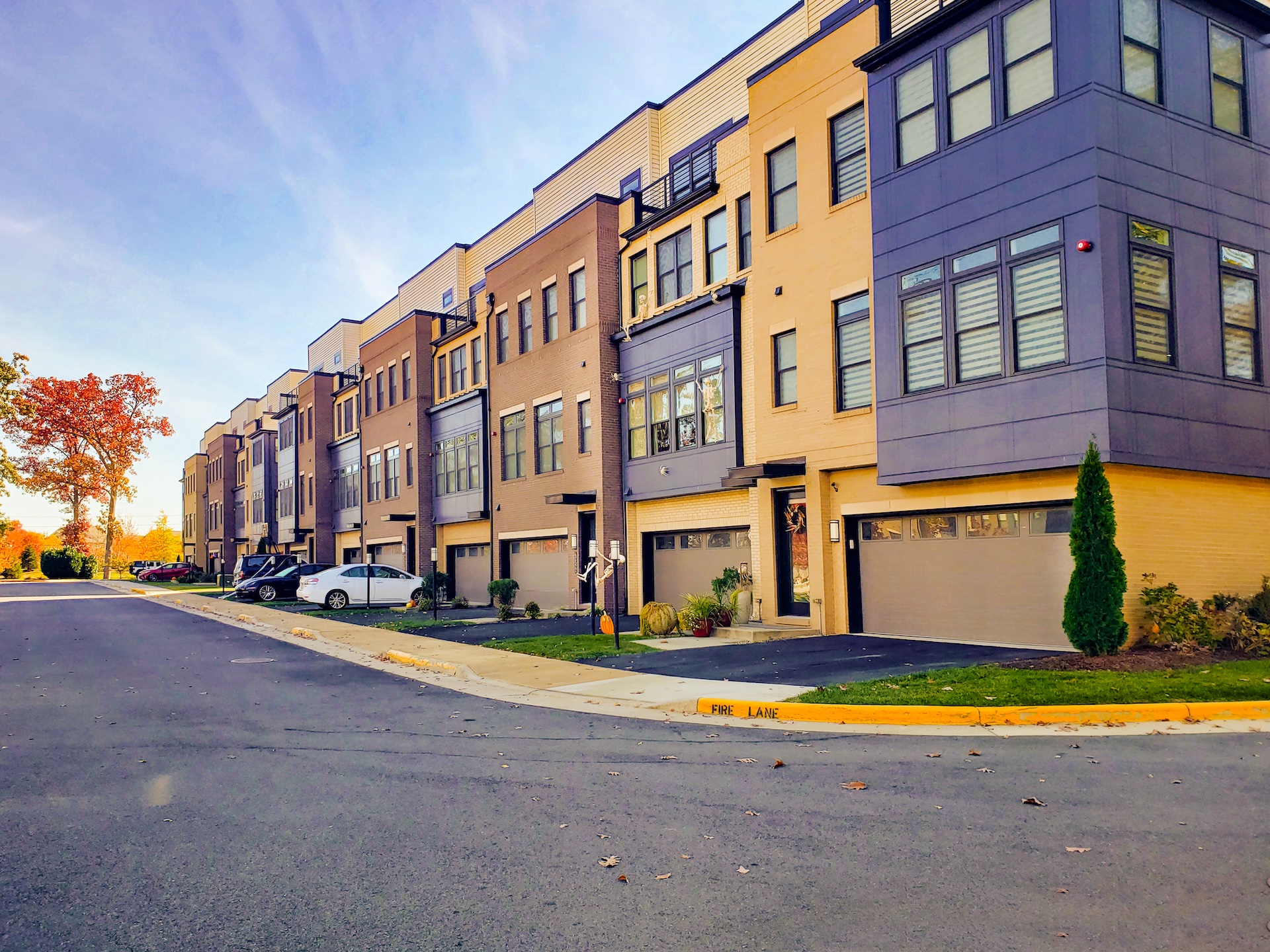 A well-kept, occupied low-rise affordable-housing community on a bright, sunny day